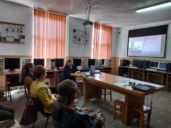 A group of people watching a powerpoint presentation